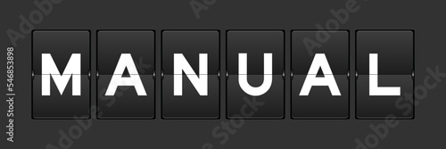 Black color analog flip board with word manual on gray background