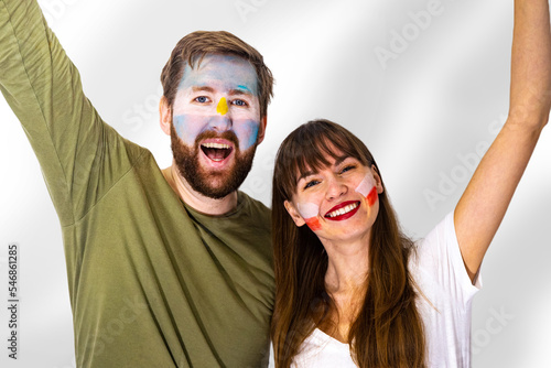 football fans of poland and argentina support their national teams together at the world championship; the concept of friendship between soccer fans; the concept of sports competition; fans isolated photo