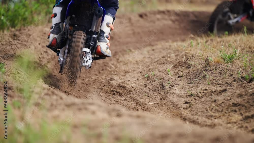 Motocross Racers Passing Curve Sand Dirt Road in slow motion Motocross Racers Passing Curve Sand Dirt Road in slow motion