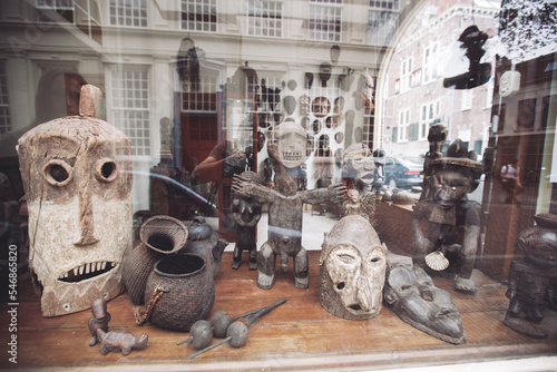 ancient full-length figures of people and faces in a shop window.