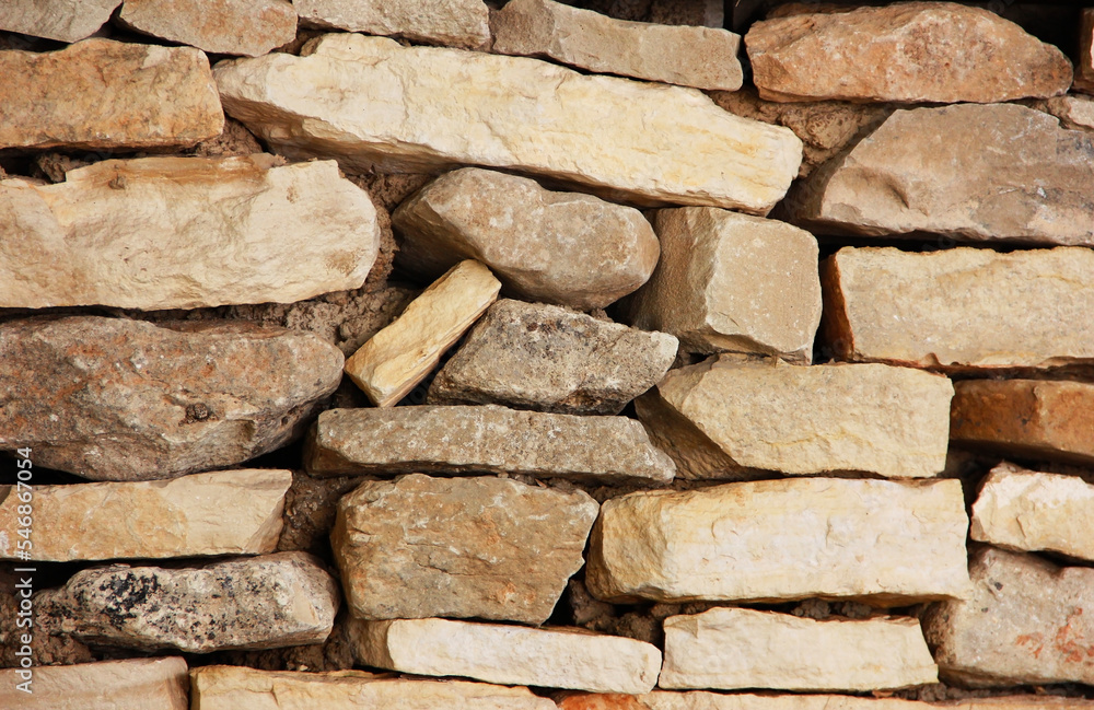 texture of a wall of brown granite stones stacked on top of each other texture of a wall of brown granite stones stacked on top of each other