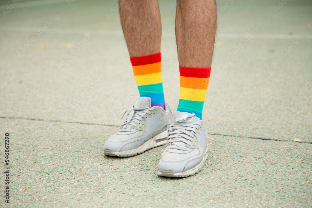 Feet with trainers and rainbow socks