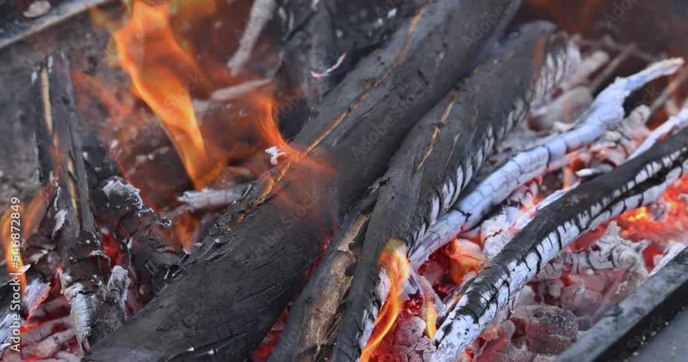Burning of firewood at end of bonfire before barbecue is cooked in BBQ grill Burning of firewood at end of bonfire before barbecue is cooked in BBQ grill