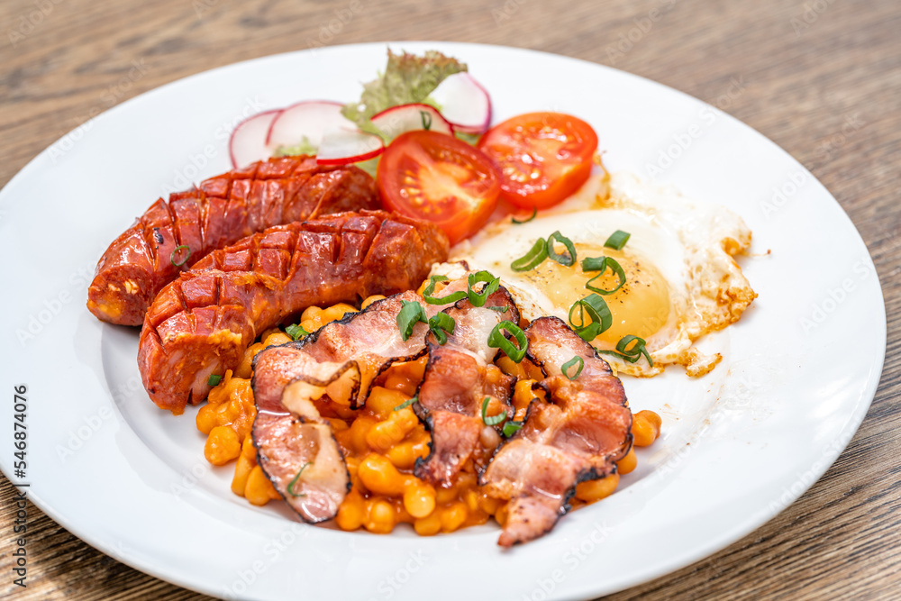 breakfast plate with sausage, bacon, egg and beans breakfast plate with sausage, bacon, egg and beans
