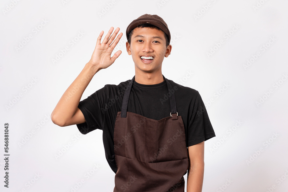 handsome barista asian man wearing brown apron and black t-shirt isolated over white background smiling friendly greeting offering handshake and welcoming handsome barista asian man wearing brown apron and black t-shirt isolated over white background smiling friendly greeting offering handshake and welcoming