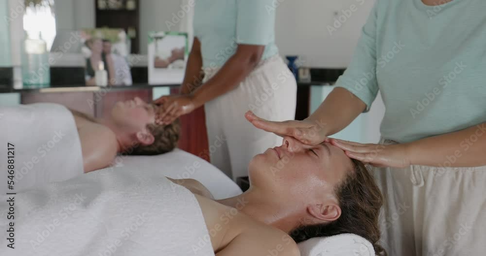 Couple receiving relaxing massage at a luxurious spa Couple receiving relaxing massage at a luxurious spa