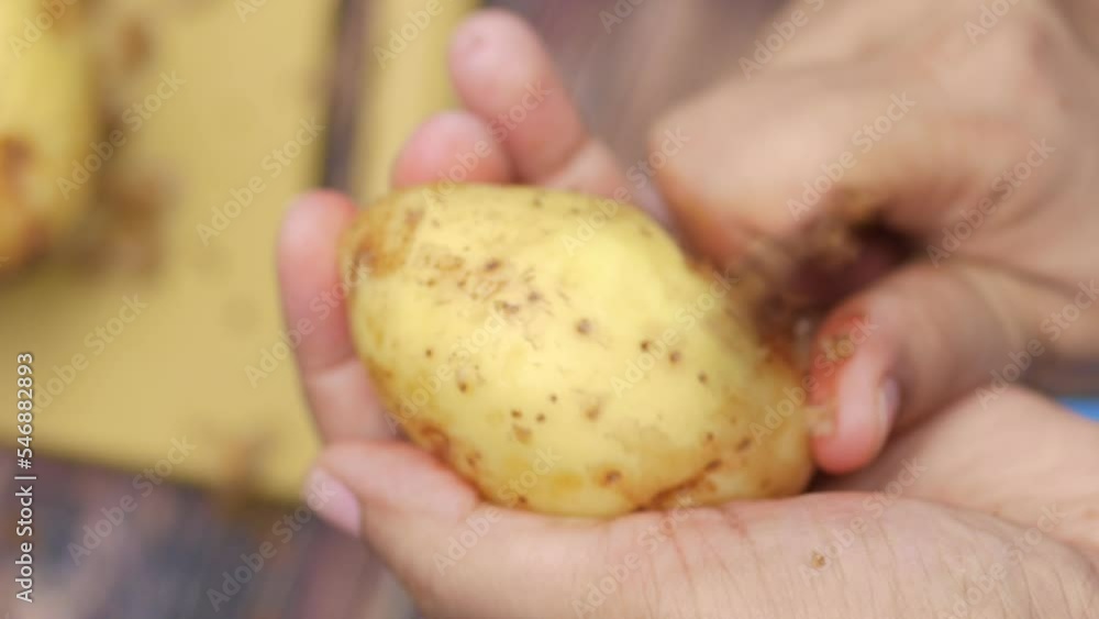 slow motion of taking skin off from a potato slow motion of taking skin off from a potato