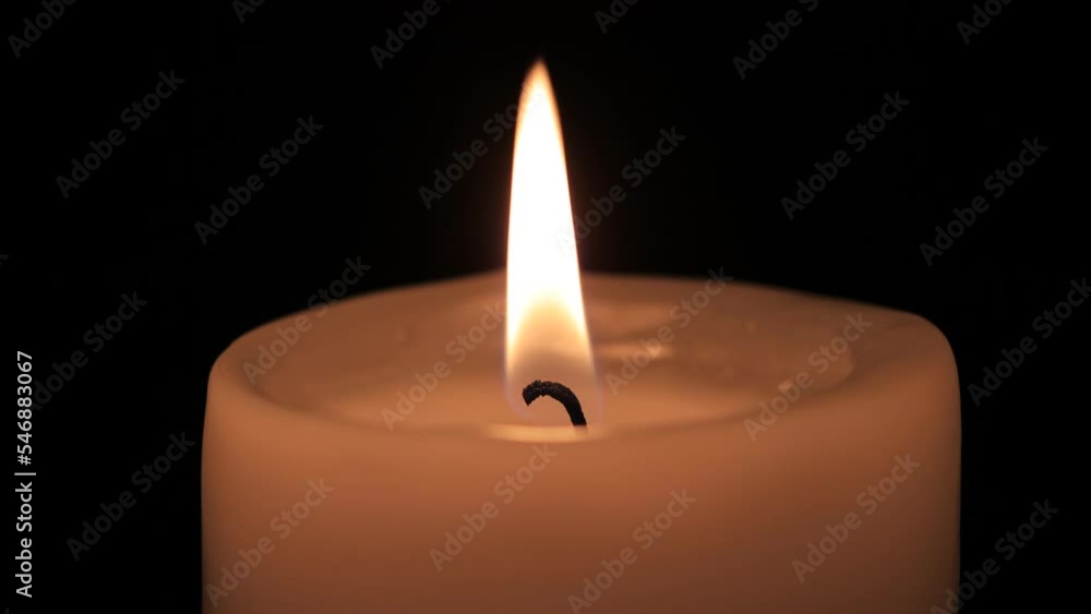 burning candle on the black backgrounds burning candle on the black backgrounds
