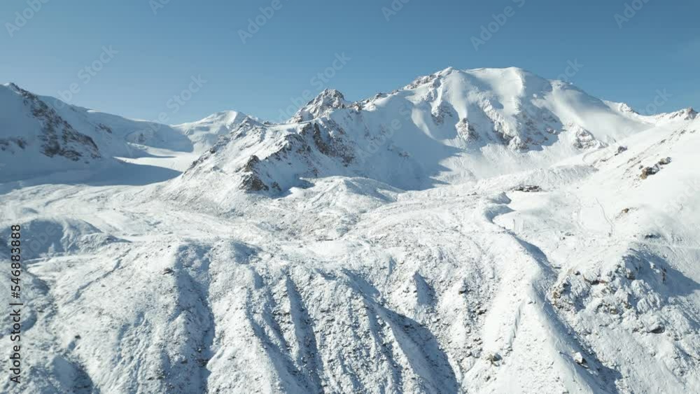 Aerial view of mountain peak in wintertime in Shambulak, Almaty, Kazakhstan. Aerial view of mountain peak in wintertime in Shambulak, Almaty, Kazakhstan.