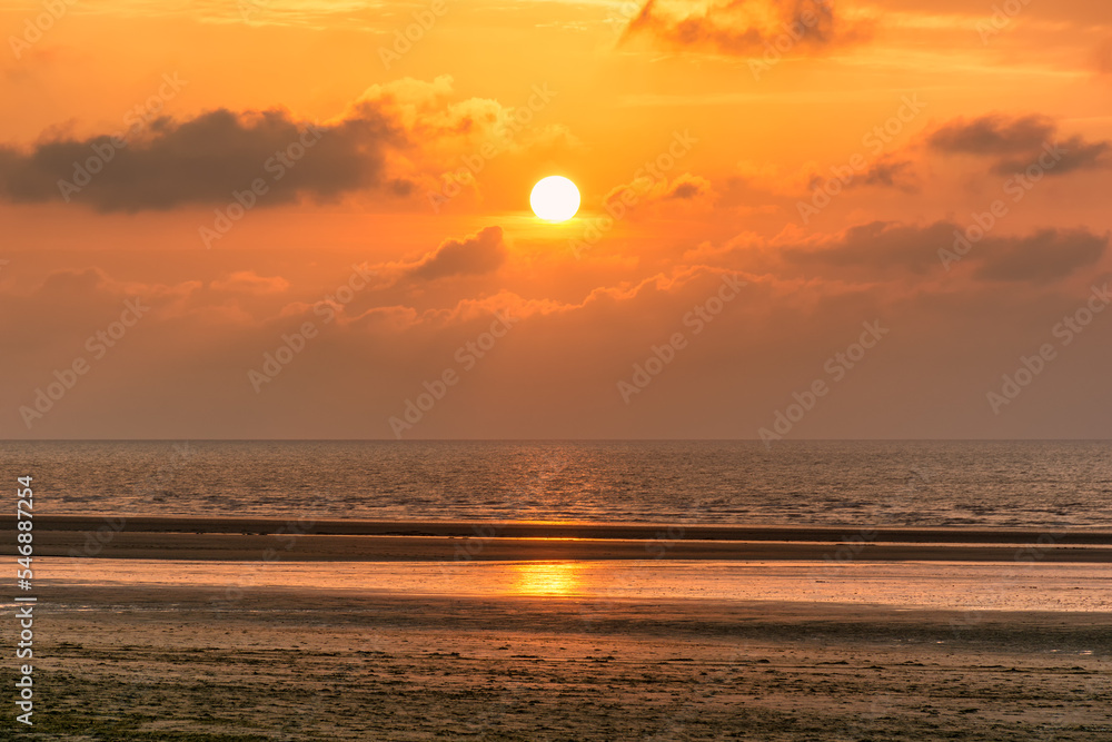 Scenic view of sunset over Deauville beach in Normandy, France against dramatic golden sky