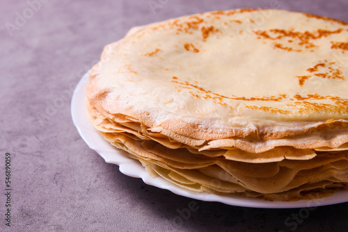 Stack of thin pancakes on plate