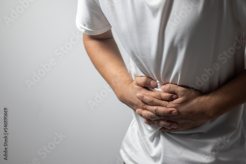 man having abdominal pain on white background Fototapet
