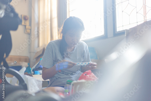 A woman cleaning and clearing unnecessary things out of her room.Natural flare include