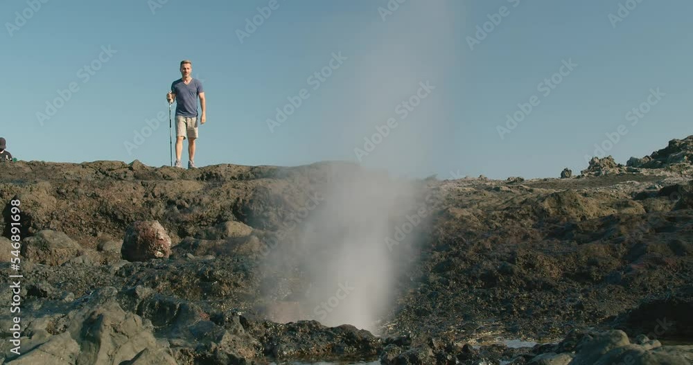 Male traveler walking near blowhole Male traveler walking near blowhole