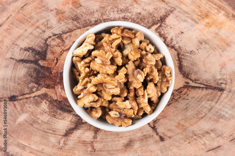 Bowl with nuts and wooden background top view Bowl with nuts and wooden background top view