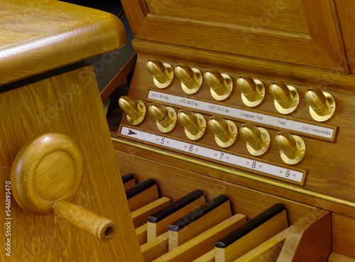 Closeup of a pipe organ pedal keyboard (pedalboard) and foot pistons photo