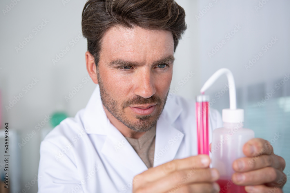chemist man uses pipette to transfer liquids chemist man uses pipette to transfer liquids