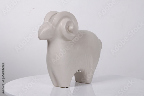 Abstract white ram ceramic display against a white background