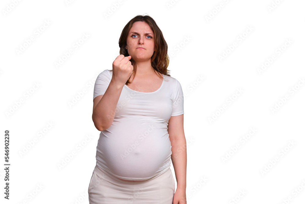 Threatening gesture with fist forward in pregnant woman, studio shot on white background Threatening gesture with fist forward in pregnant woman, studio shot on white background