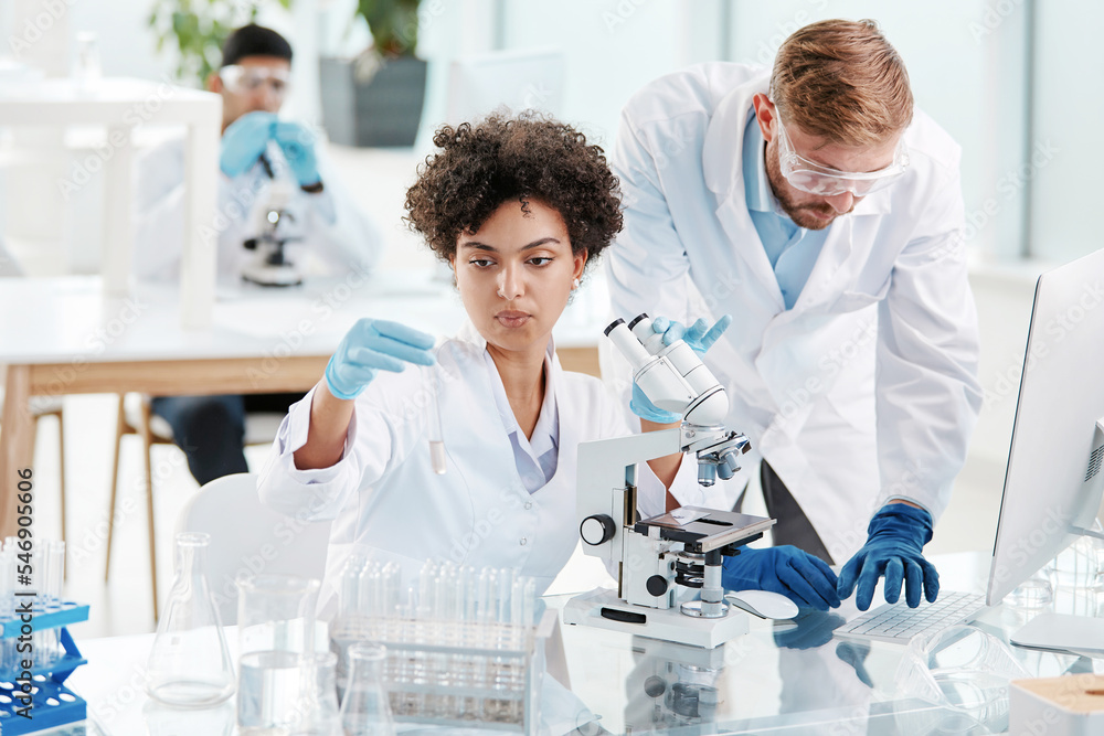 team of research scientists conducts research in a modern laboratory team of research scientists conducts research in a modern laboratory