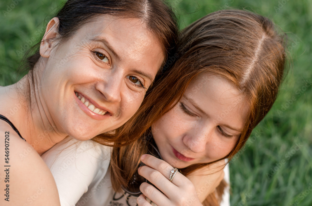 Portrait of a mother with her daughter in nature, close-up Portrait of a mother with her daughter in nature, close-up