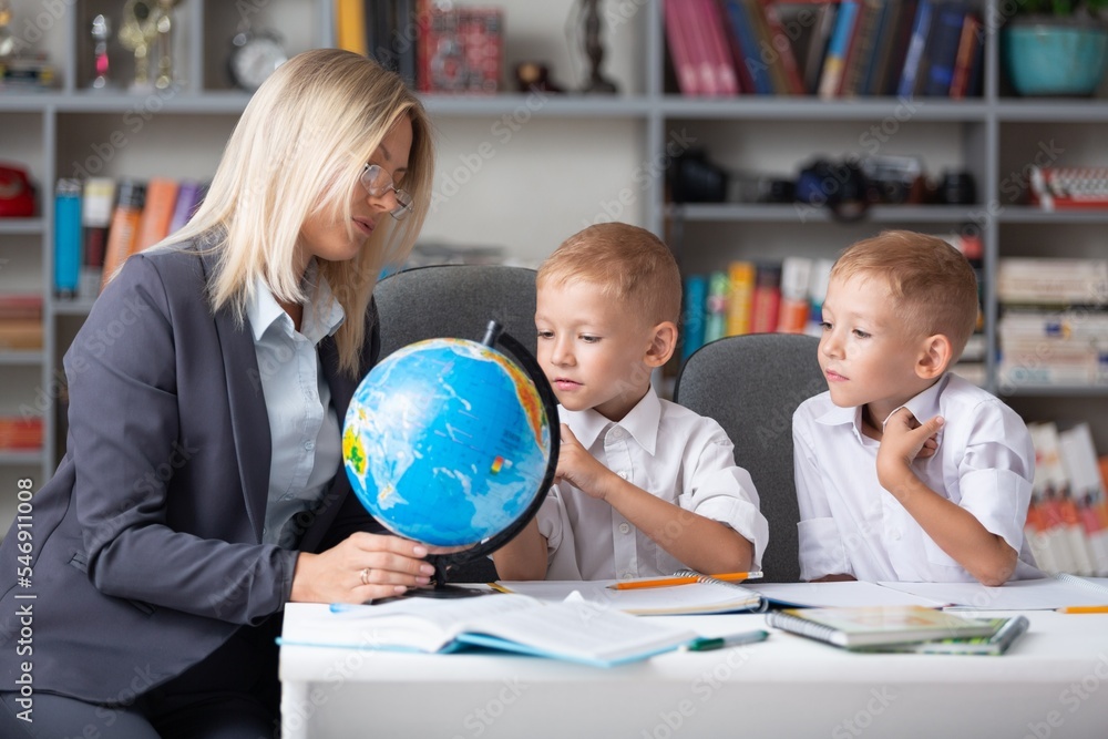 Fototapeta premium Teacher and children with globe, geography interesting learning.