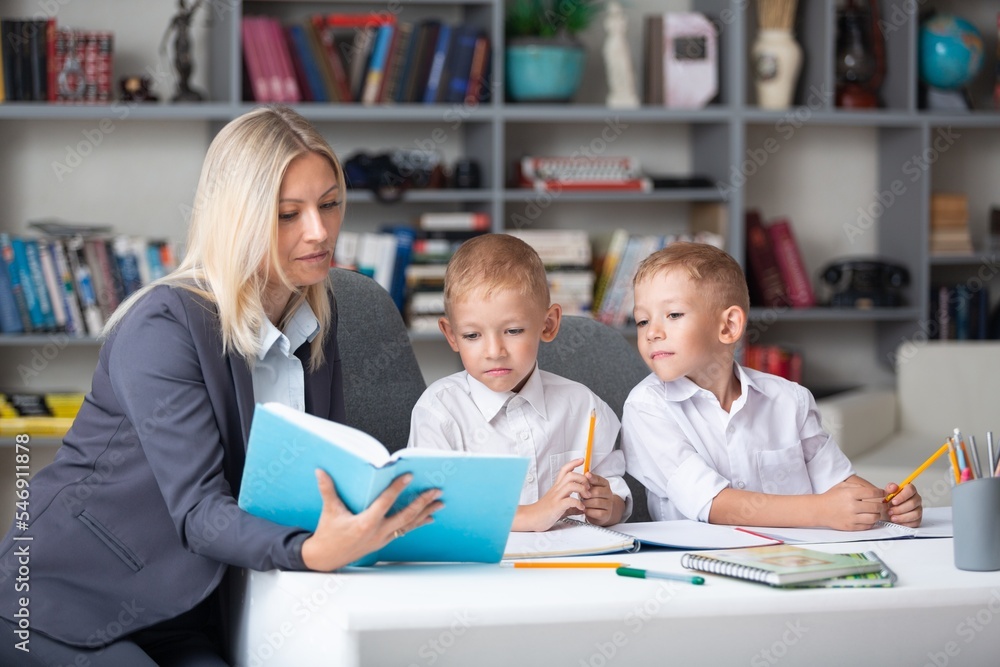 Learning child. Young teacher and school pupils sitting in classroom. Learning child. Young teacher and school pupils sitting in classroom.