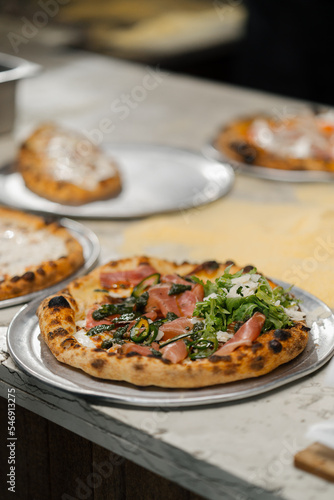 Professional kitchen - chef preparing delicious pizza, pizza cooking process