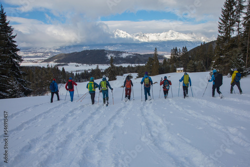 A group of tourists is enjoying a hike in the snowy winter mountains, Small Tatras, Carpathians, Slovakia