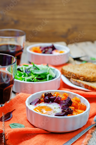 Beet Sweet potato baked eggs on a wood background