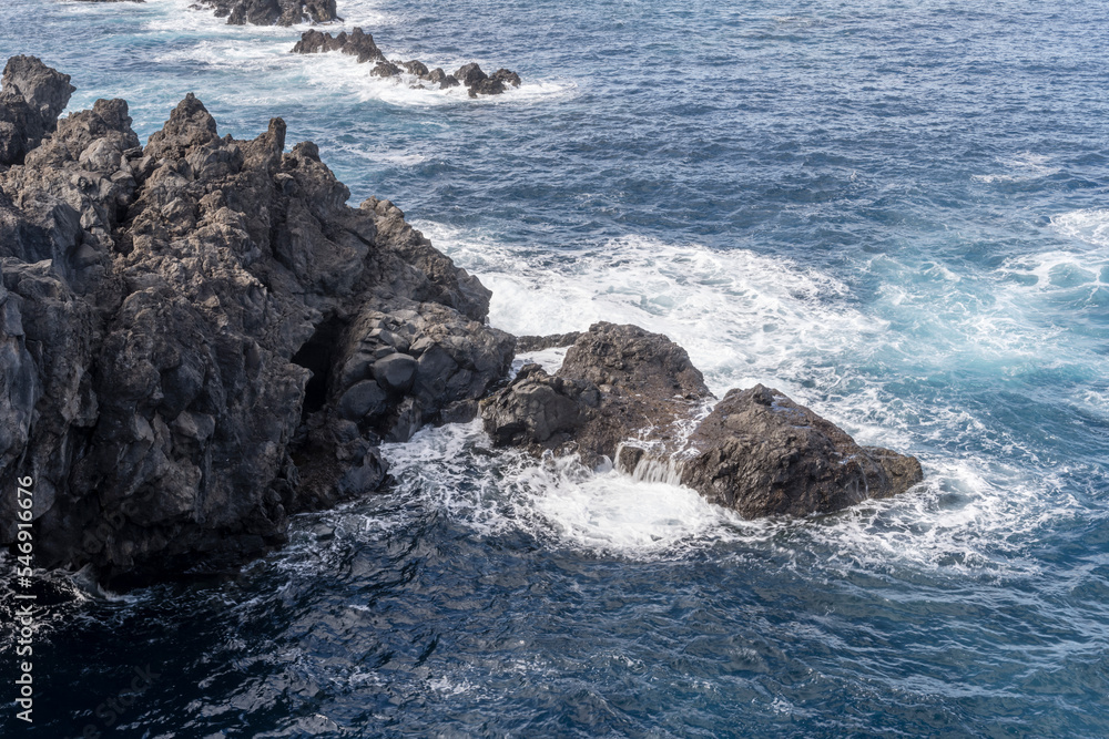 ocean waves dashing on volcanic cliffs at Porto Moniz, Madeira