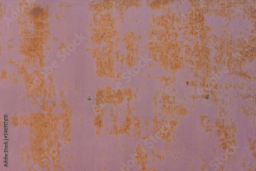 Rusty metallic plate. Backdrop of a weathered door with corrosion © madrolly