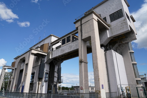 Low angle view on upper part construction of river locks with open gate situated next to hydroelectric power station Kembs on the river Rhine. 