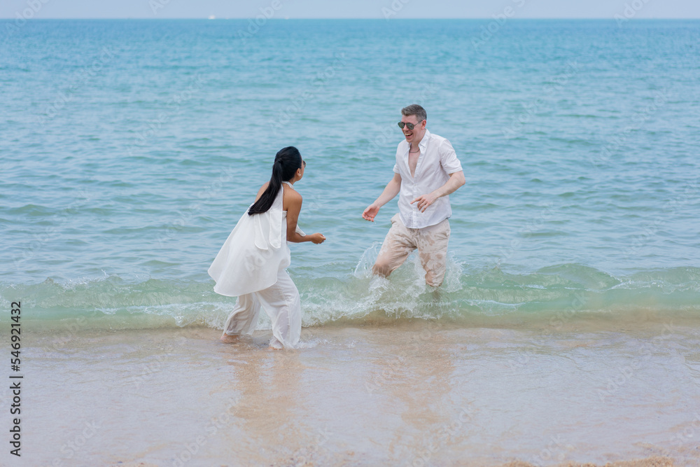 Happy wedding couple running by the beach. Romantic feelings and vibes. Happy wedding couple running by the beach. Romantic feelings and vibes.