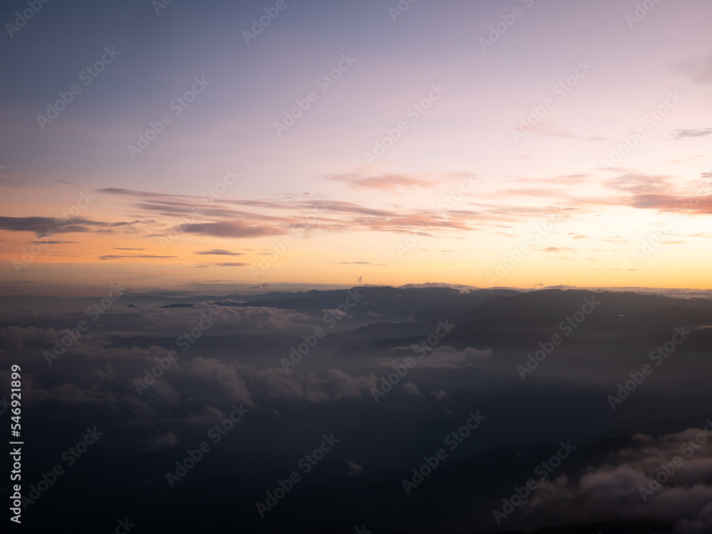 Sunrise in the Mountains of Antioquia, Colombia with a Yellow Sky and Full of Clouds