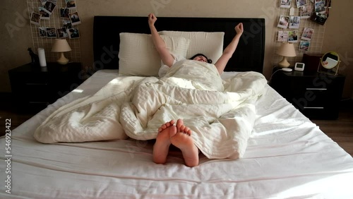 woman awaking in her bed in the morning