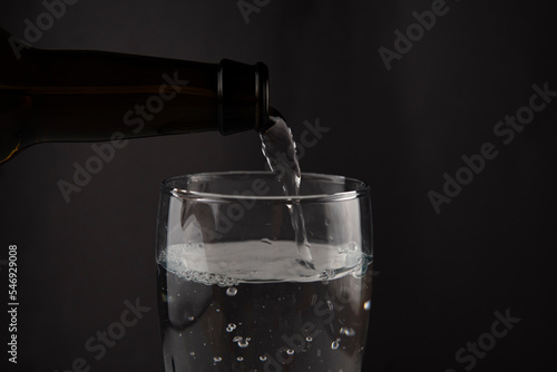 water pouring from a bottle into a glass