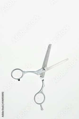 Professional Haircutting Scissors levitation. Open hairdresser scissors on a white background.