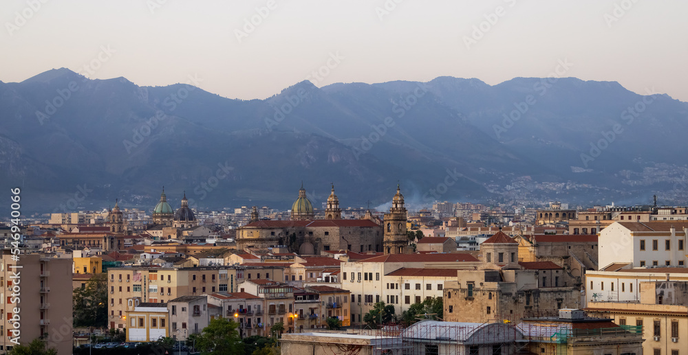 Residential Homes and Historic Buildings with mountains in background in Palermo, Sicily, Italy. Sunrise Sky.