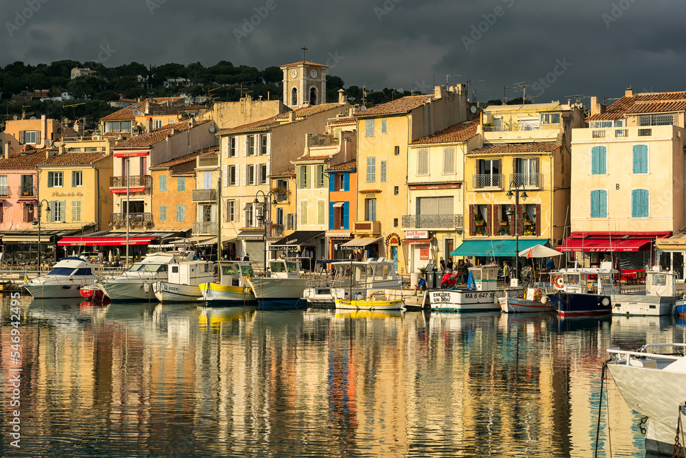 Scenic view of small village of Cassis in south of France with mirror reflection to Mediterranean sea against dramatic sky