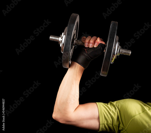 Strong arm hand lifting dumbbell close up. Pumping, sport concept
