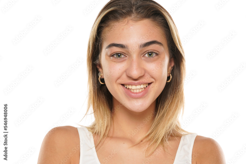 a young smiling woman without makeup with long hair on a white background a young smiling woman without makeup with long hair on a white background