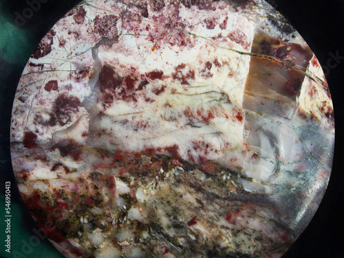 Wonderful eudialyte or marble texture, top view of jewelry box, macro photo. photo