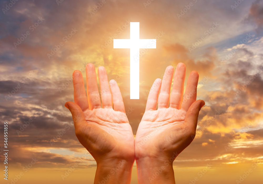 Christian crucifix in sky. Catholic cross near sunset. Christian