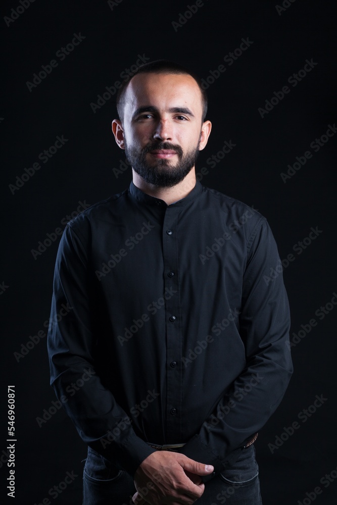 Fototapeta premium Beard man in black shirt on black background