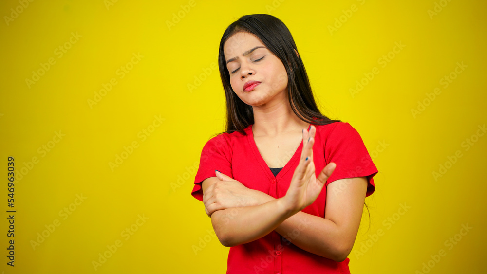 Portrait of a Asian beautiful young woman unhappy or confident standing say no, studio shot isolated yellow background, Indian female pose saying reject gesture with copy space Portrait of a Asian beautiful young woman unhappy or confident standing say no, studio shot isolated yellow background, Indian female pose saying reject gesture with copy space