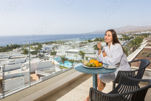 Smiling woman with cup of coffee on terrace
