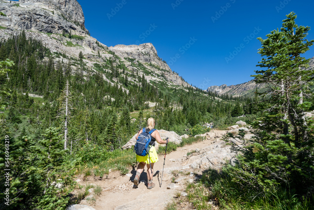 Woman hiker makes her way though the Cascade Canyon trail in Grand Teton National Park