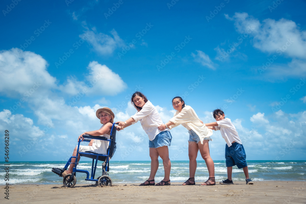 Happy Asian diversity generation family standing on tropical beach in summer at daytime Happy Asian diversity generation family standing on tropical beach in summer at daytime