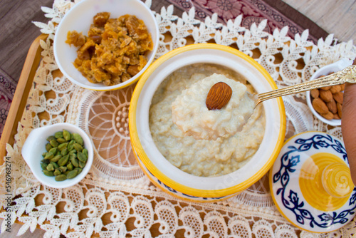 Kheer, Payasam, Phirni or rice pudding in bowl with ingretients. Healthy and home made dessert made with rice, milk and jaggery. It is very famous sweet dish of India. photo